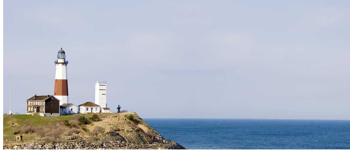 A lighthouse on a cliff overlooking sea